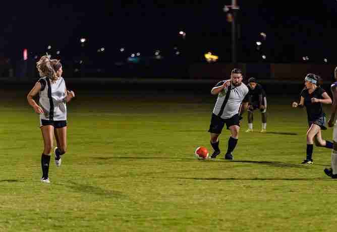 Men and women playing soccer